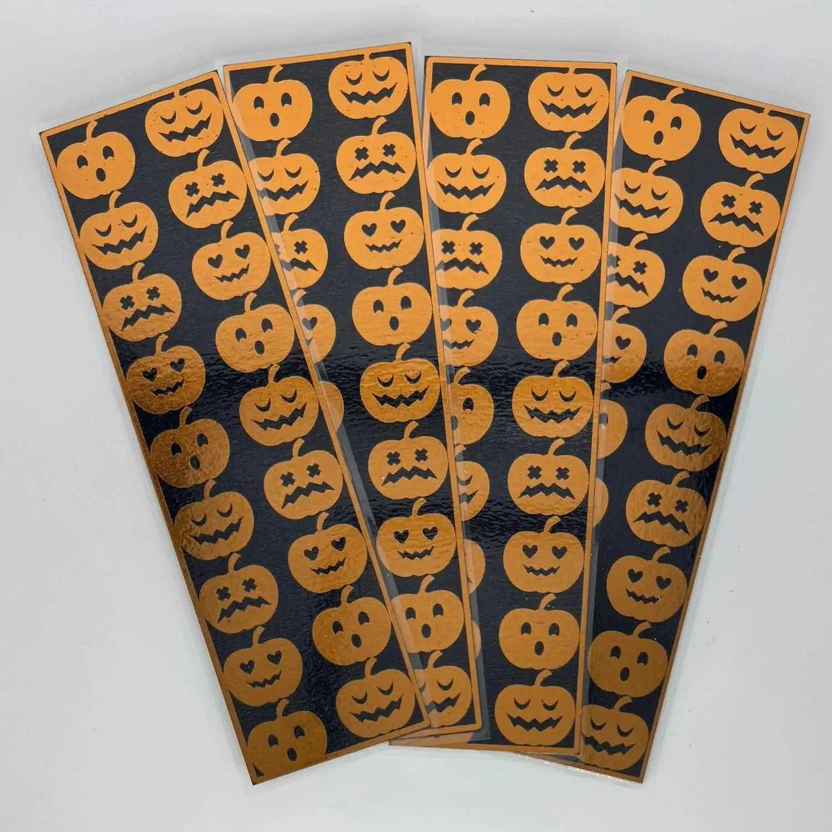 Halloween pumpkin stickers with spooky faces on black background