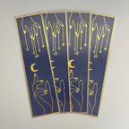 Elegant navy blue bookmarks with gold foil hands, moons, and stars design