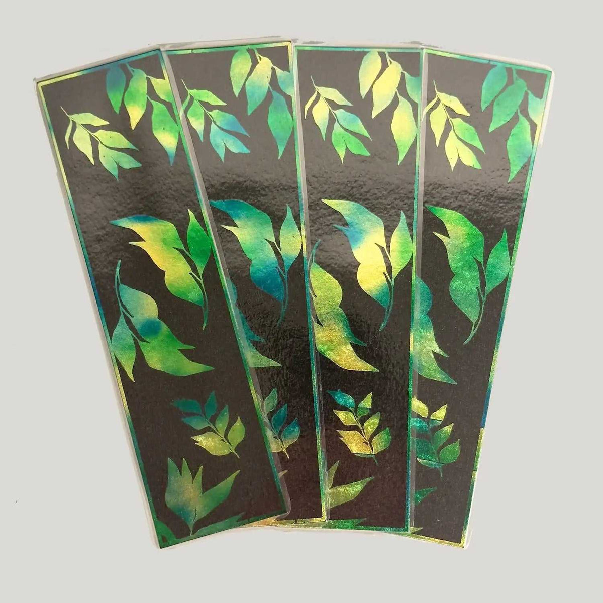 Leaf patterned decorative cards with green and yellow watercolor design on dark background
