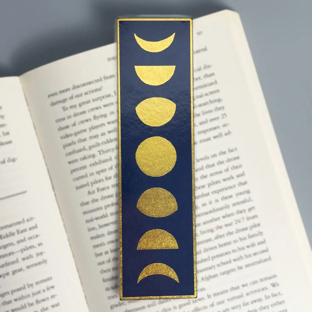 Navy blue bookmark with gold moon phases, elegant reading accessory for book lovers
